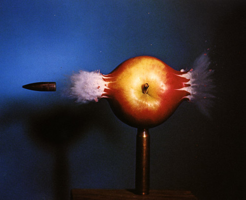 A bullet blasting through a delcious apple. It'd be cool to see this happen to a carmel apple too. Except it would be more tragic.