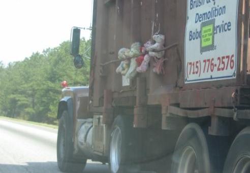 creepy kids toys on a garbage truck