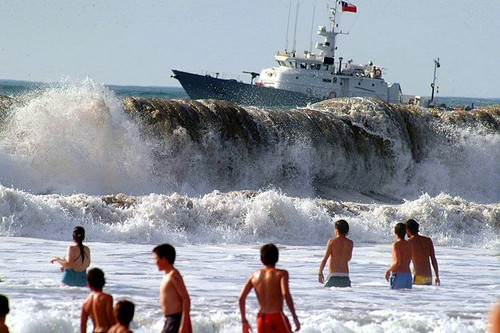 That wave is about to topple that ship right into the swimmers