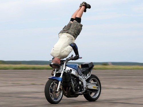 Stunter rockets down the track on his head
